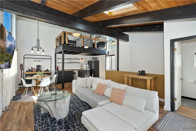 a living room with furniture a fireplace and a table