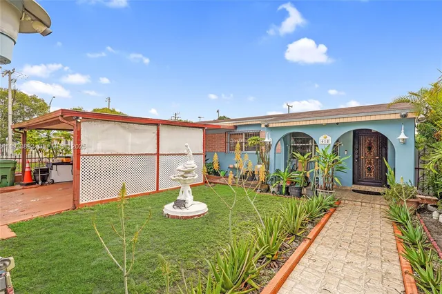 a front view of a house with garden