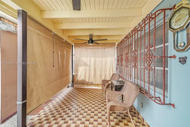 a view of a hallway with wooden floor and door