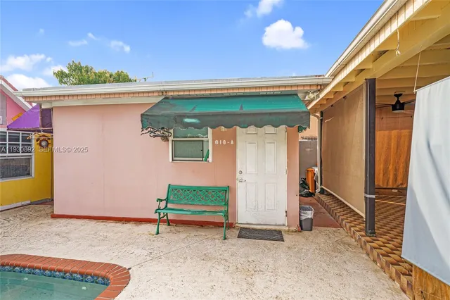 a backyard of a house with table and chairs
