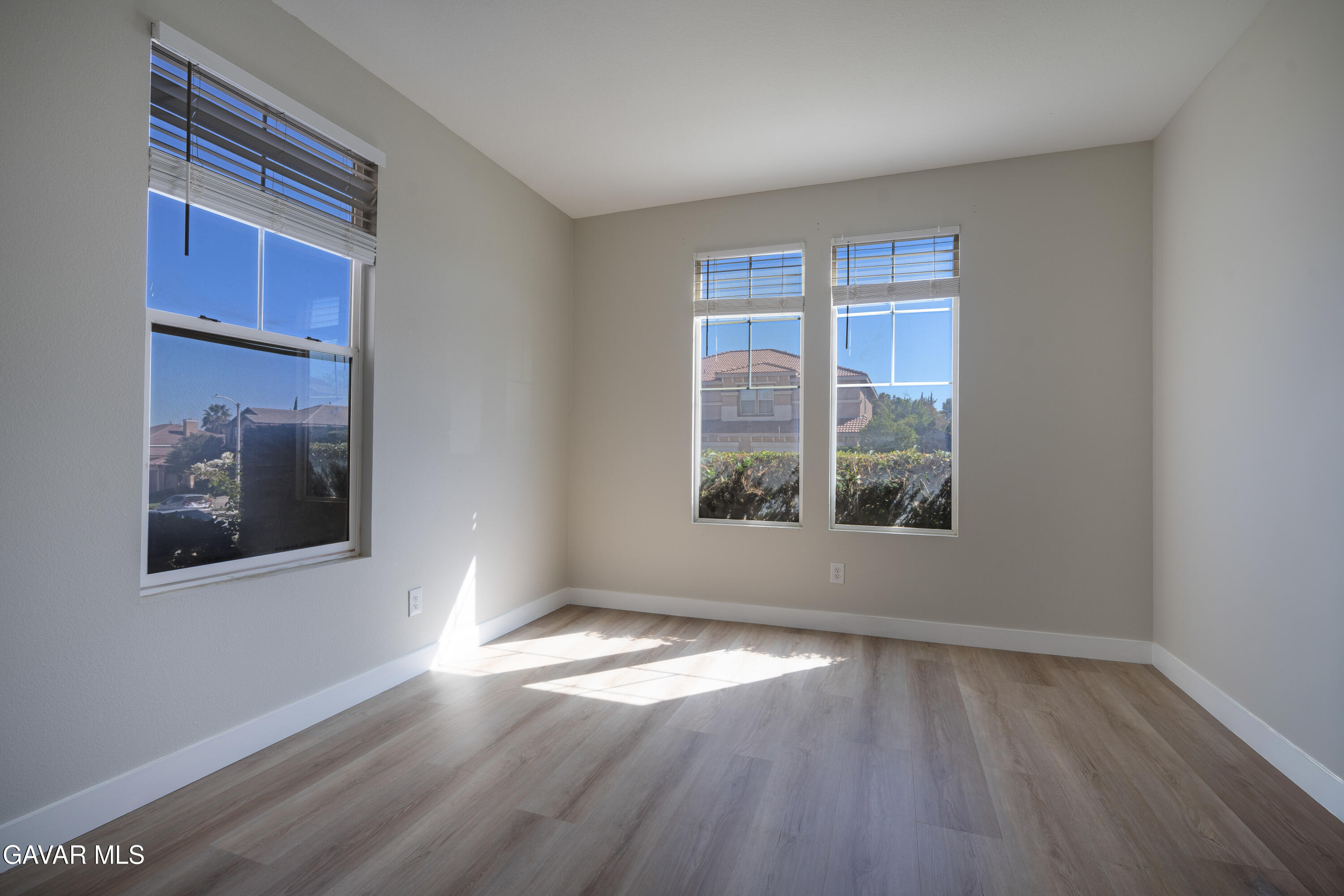 40271 Preston Road Palmdale, CA 93551 - Photo 13 of 38 a view of empty room with wooden floor and fan
