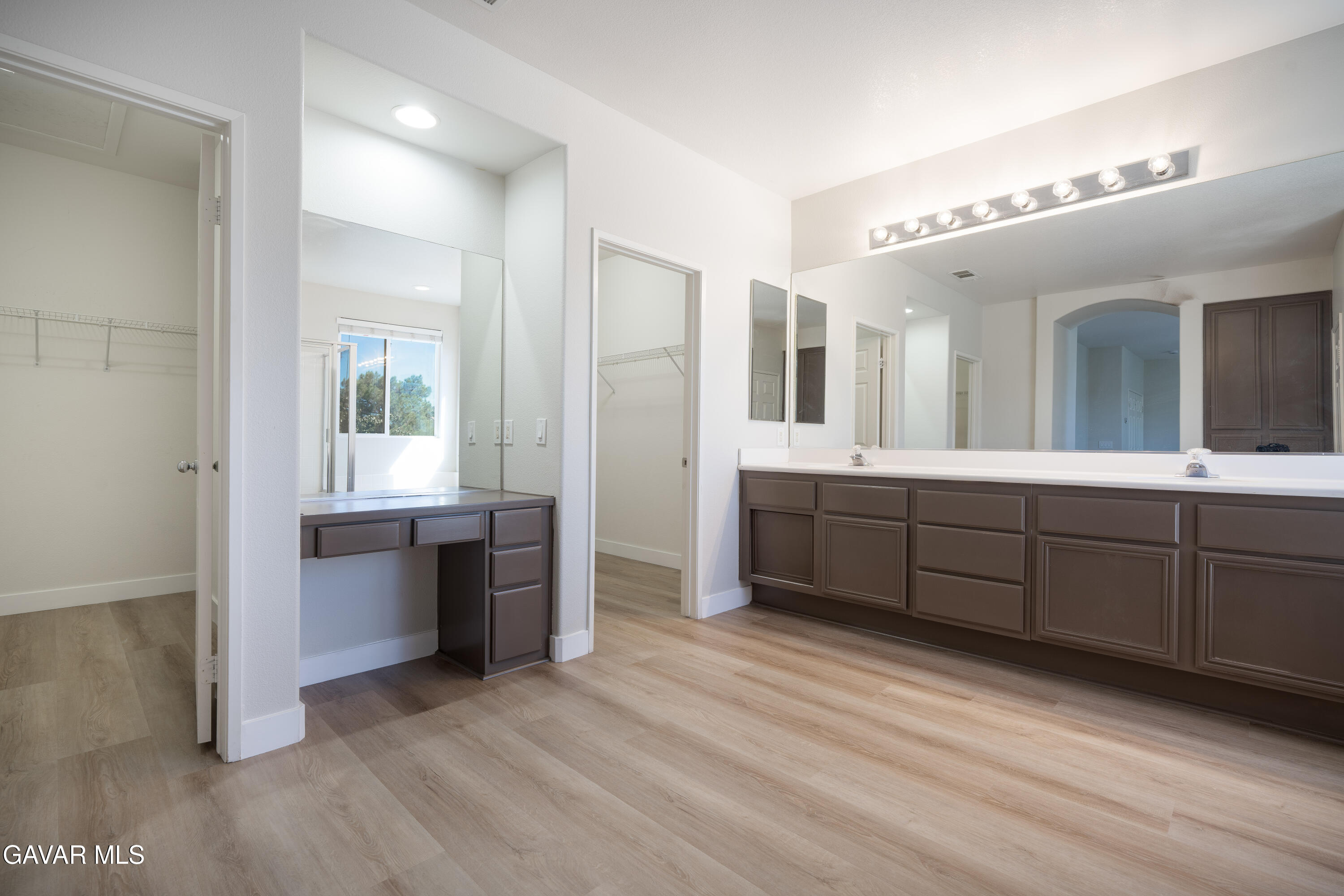 40271 Preston Road Palmdale, CA 93551 - Photo 20 of 38 a spacious bathroom with a granite countertop sink mirror and cabinets