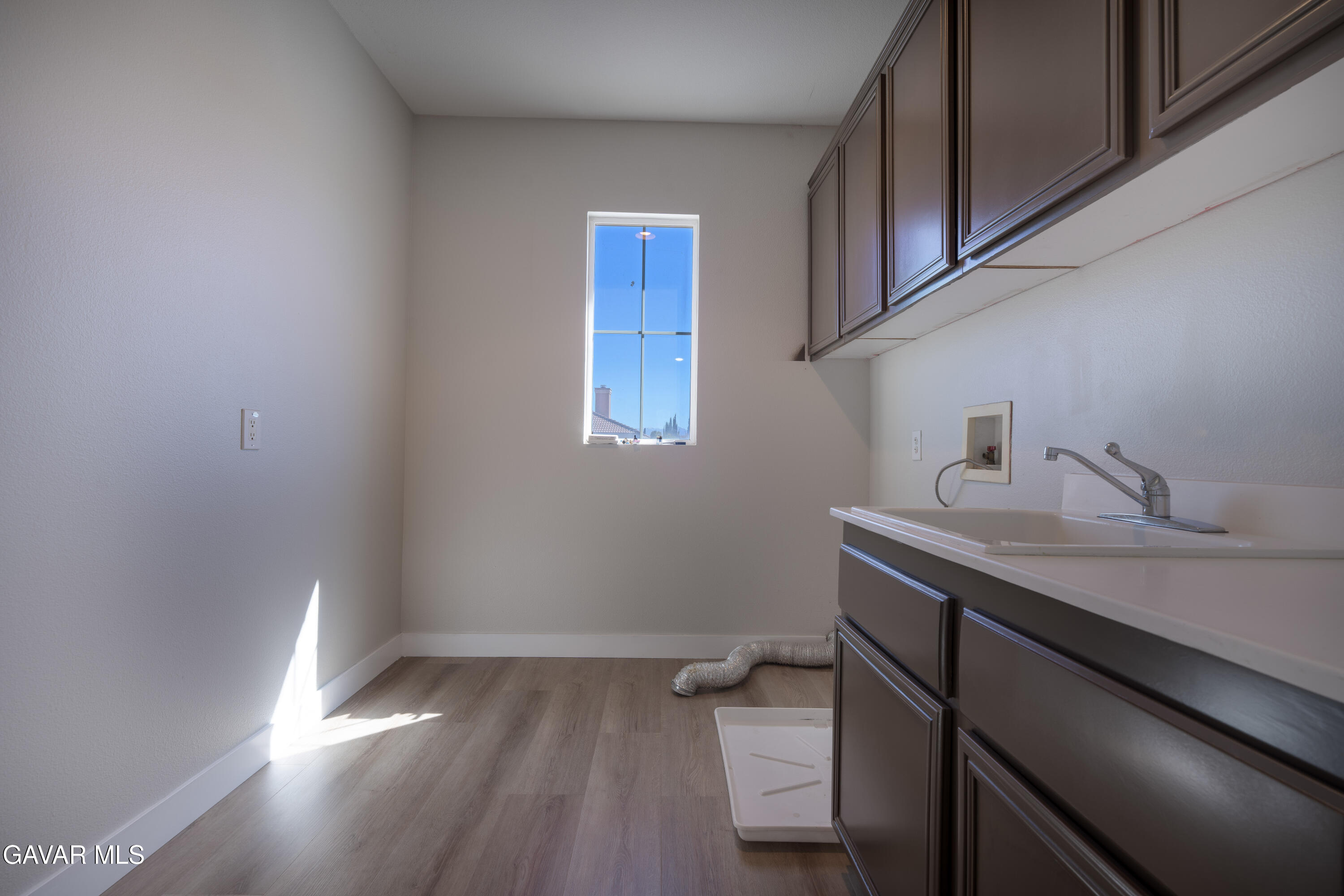 40271 Preston Road Palmdale, CA 93551 - Photo 26 of 38 a view of a room with wooden floor and cabinets