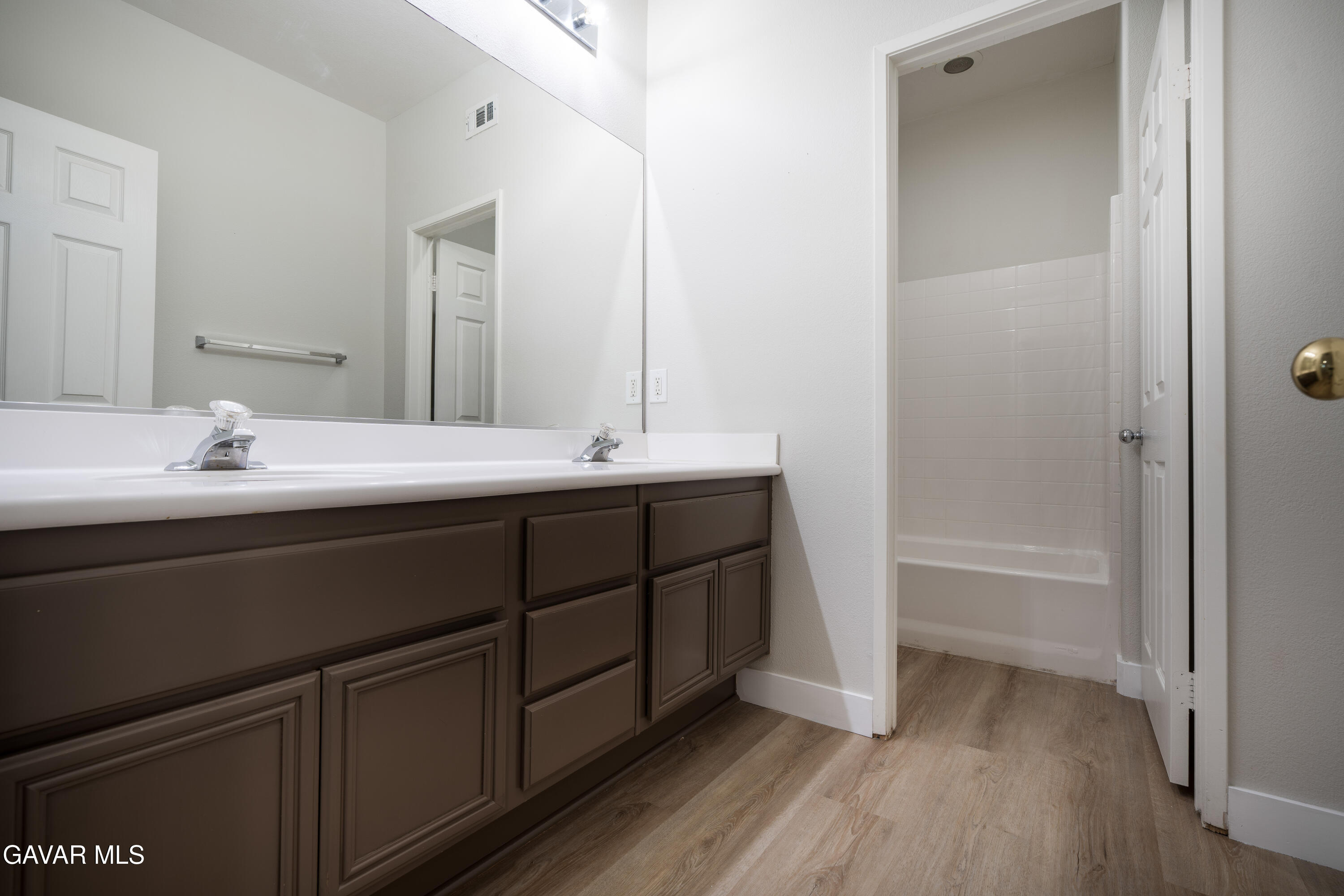 40271 Preston Road Palmdale, CA 93551 - Photo 31 of 38 a bathroom with a double vanity sink and mirror