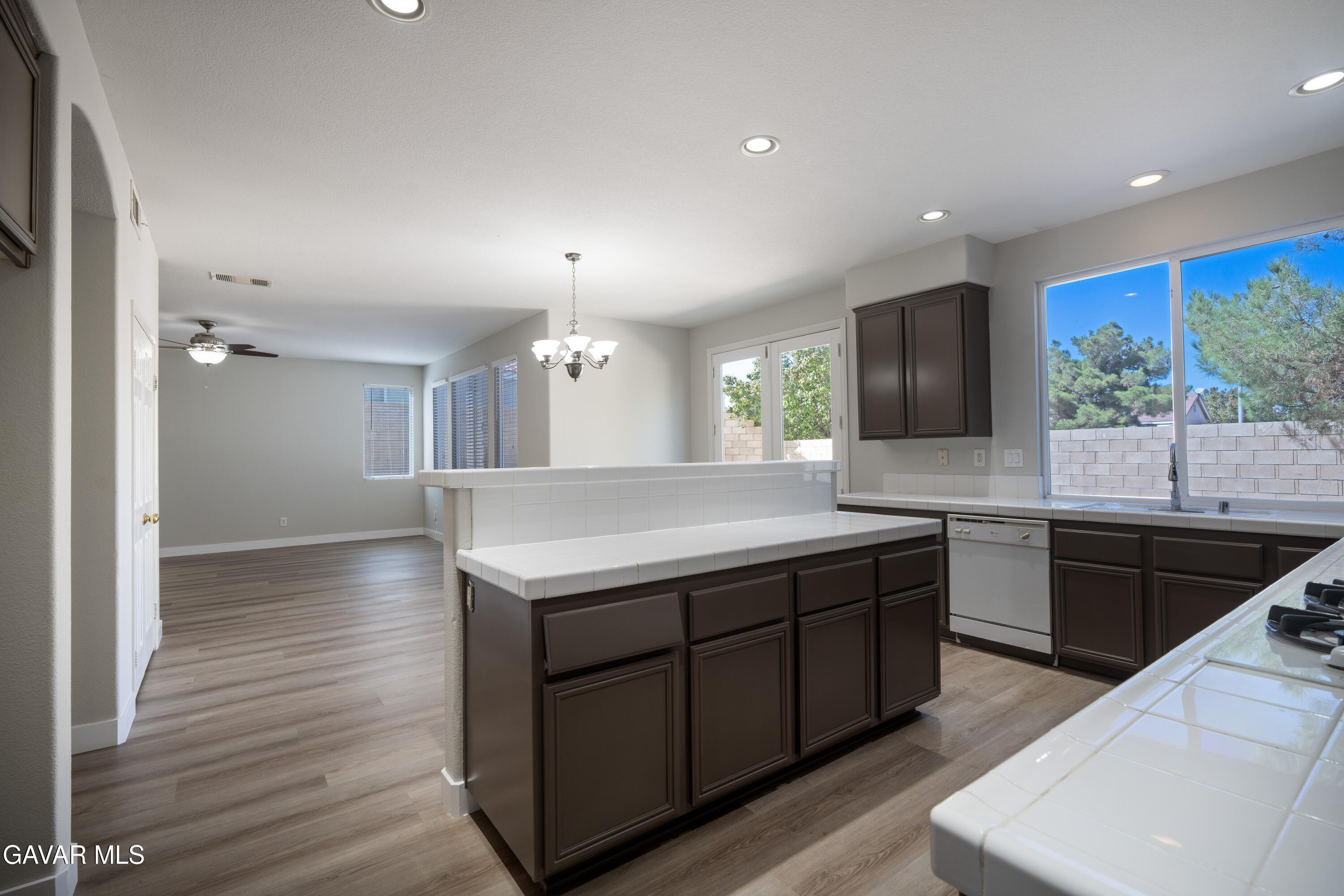 40271 Preston Road Palmdale, CA 93551 - Photo 8 of 38 a spacious kitchen with stainless steel appliances granite countertop a sink a stove and a wooden floors