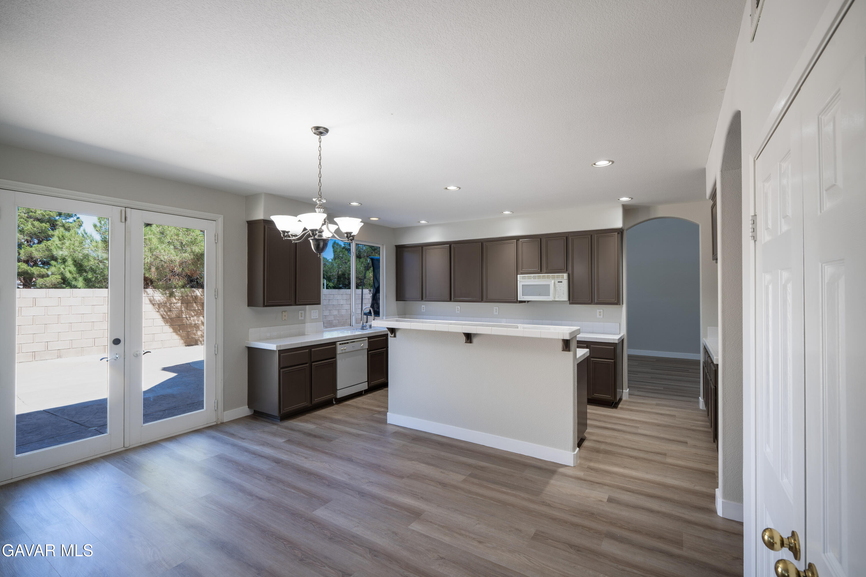 40271 Preston Road Palmdale, CA 93551 - Photo 10 of 38 a kitchen with a refrigerator and a wooden floor
