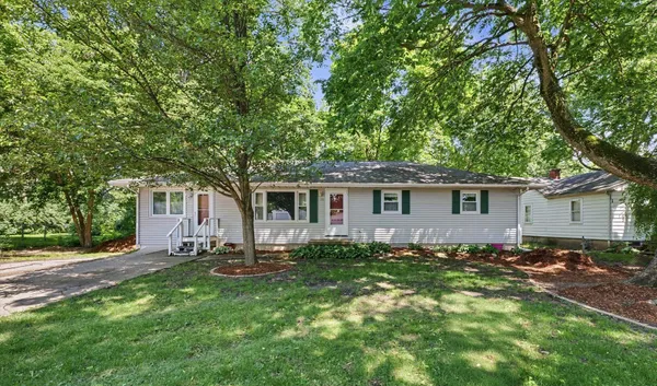 a front view of house with yard and trees