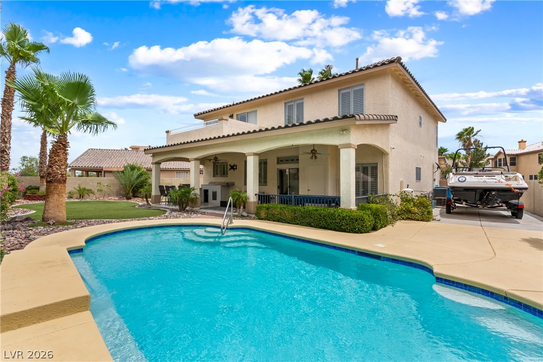 708 Vortex Avenue Henderson, NV 89002 - Photo 49 of 71 An inviting backyard oasis offers a sparkling in-ground pool and spacious covered patio perfect for outdoor entertaining.