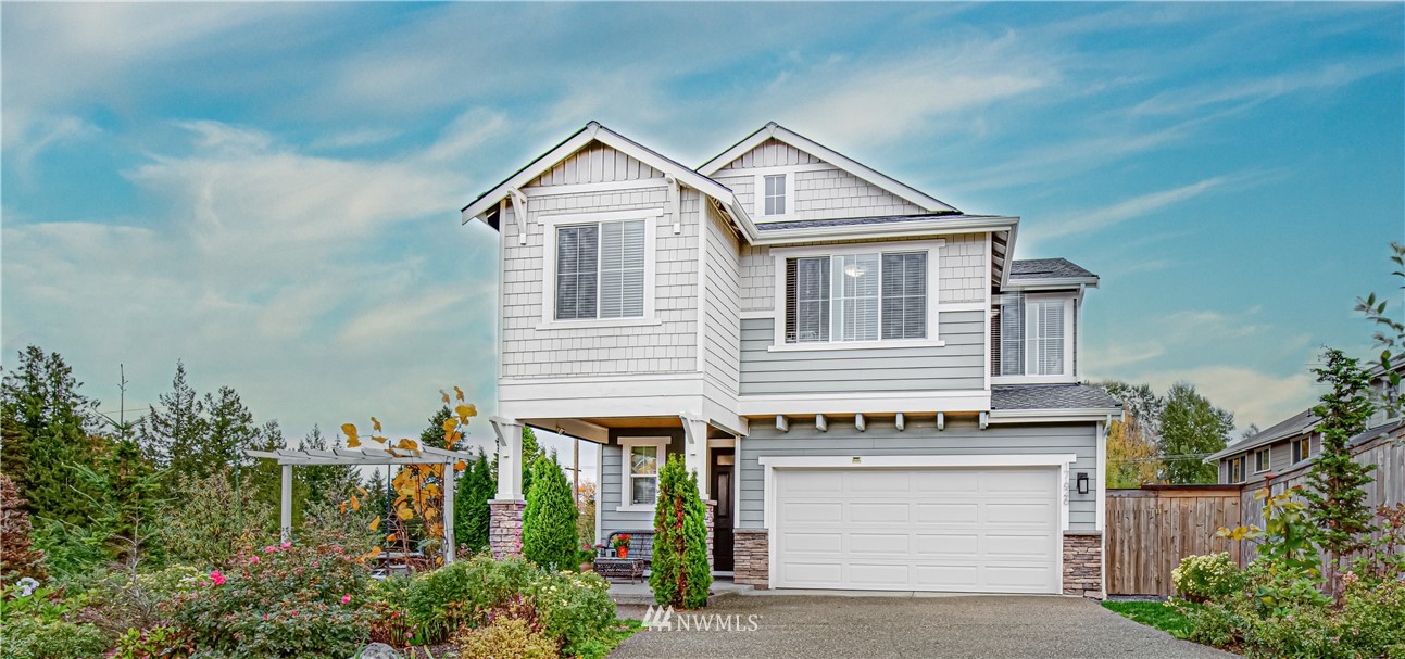 17626 115th Place Southeast Renton, WA 98055 - Photo 1 of 18 a front view of a house with a garden and plants