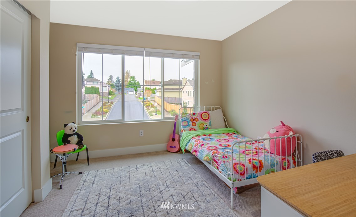 17626 115th Place Southeast Renton, WA 98055 - Photo 12 of 18 a bedroom with a bed and a window