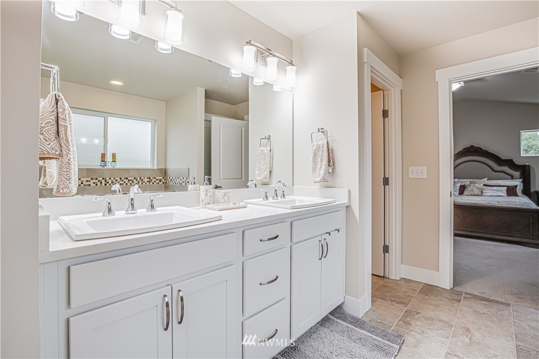 17626 115th Place Southeast Renton, WA 98055 - Photo 13 of 18 a bathroom with a double vanity sink and mirror