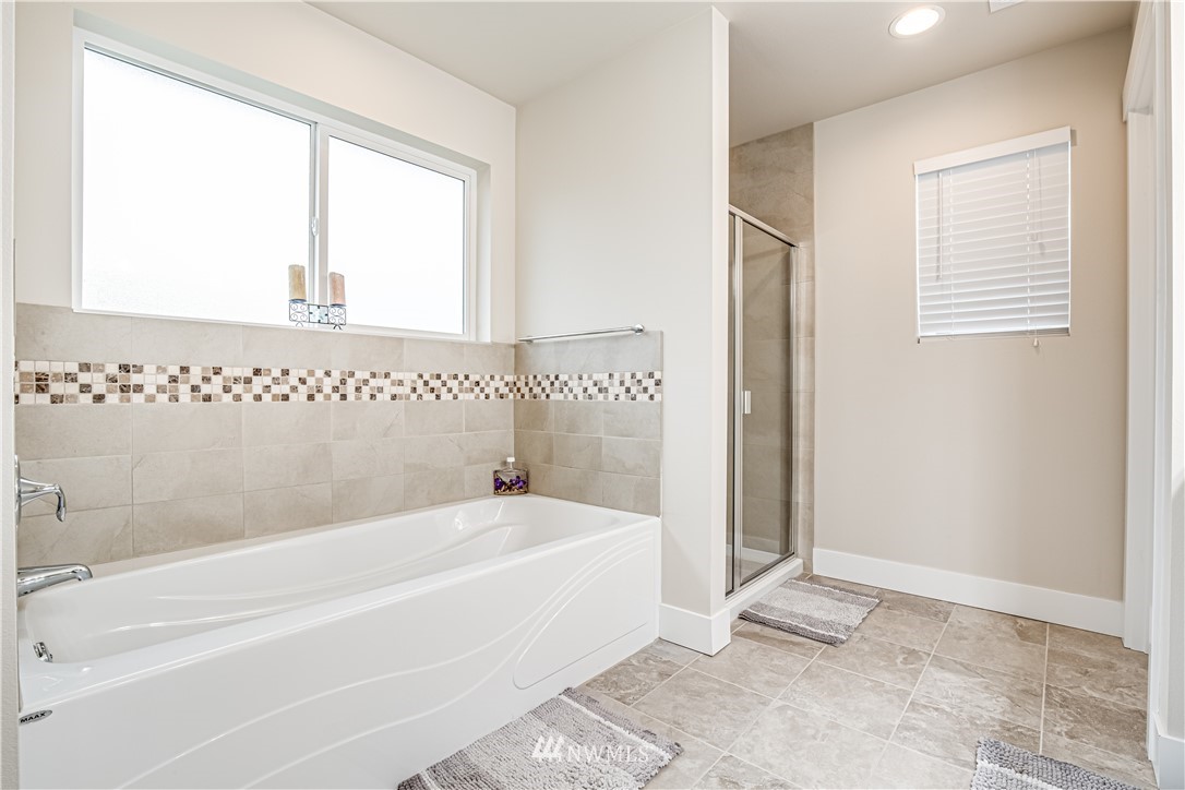 17626 115th Place Southeast Renton, WA 98055 - Photo 14 of 18 a bathroom with a bathtub and a shower