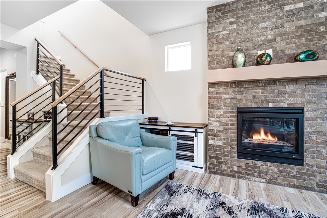 17626 115th Place Southeast Renton, WA 98055 - Photo 3 of 18 a living room with furniture and a fireplace