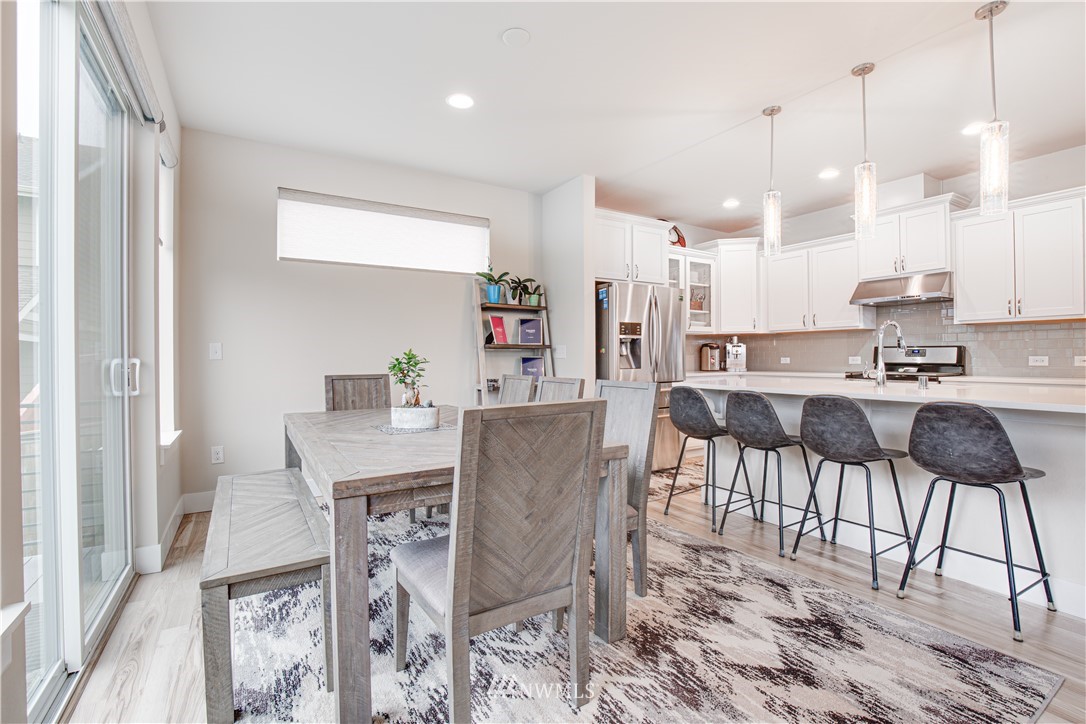 17626 115th Place Southeast Renton, WA 98055 - Photo 4 of 18 a view of a dining room with furniture and wooden floor