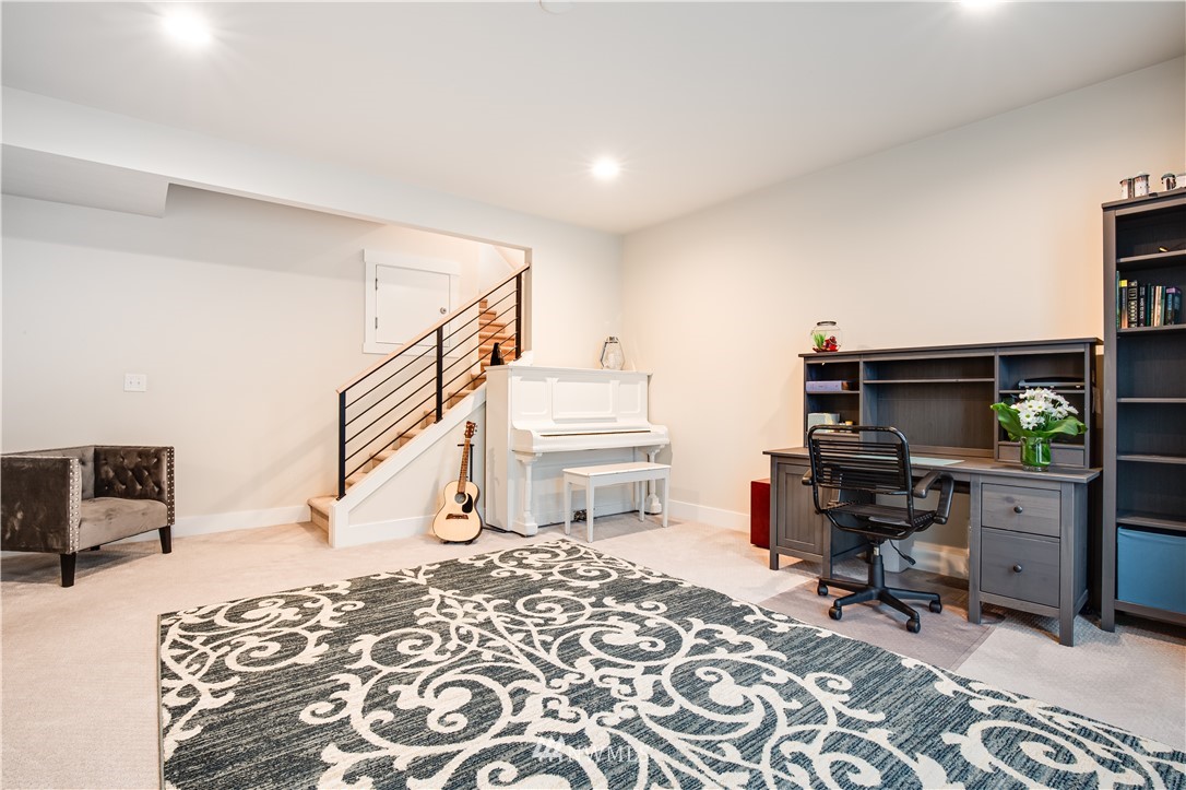 17626 115th Place Southeast Renton, WA 98055 - Photo 5 of 18 a bedroom with furniture and a flat screen tv