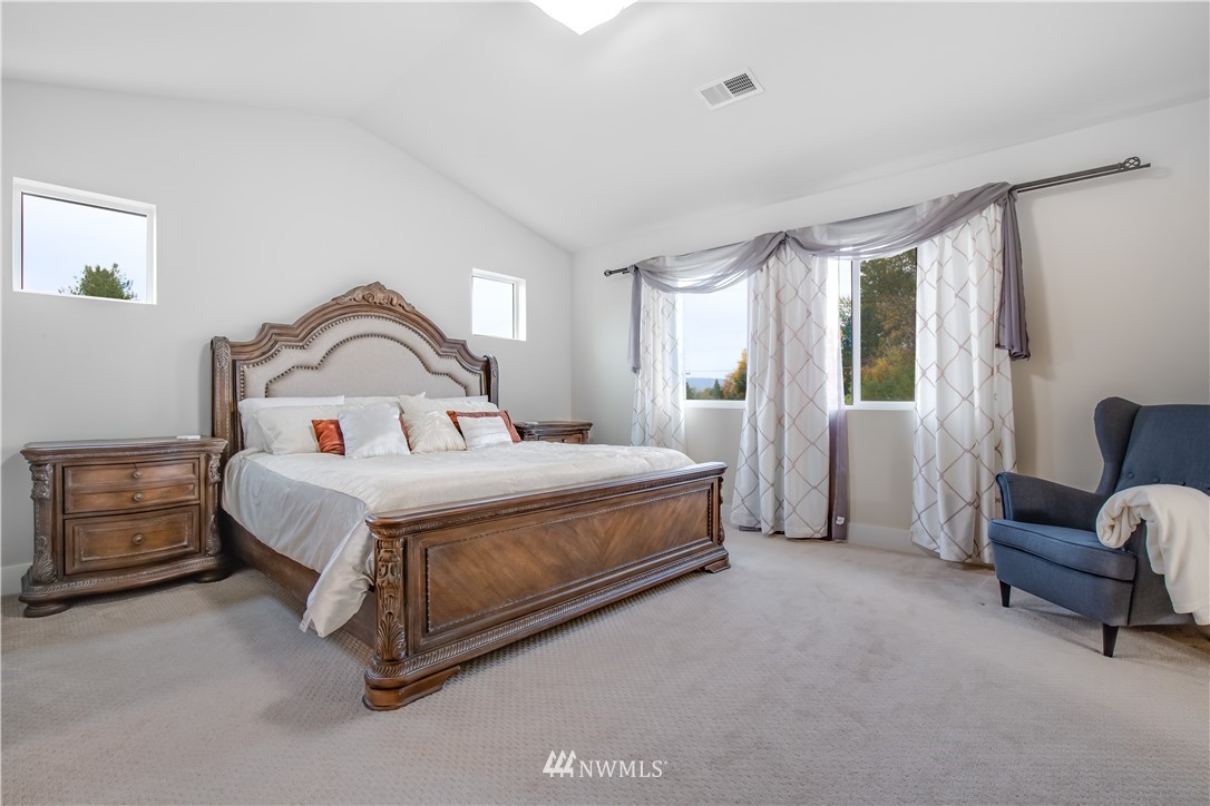 17626 115th Place Southeast Renton, WA 98055 - Photo 7 of 18 a bed room with a bed and a chair