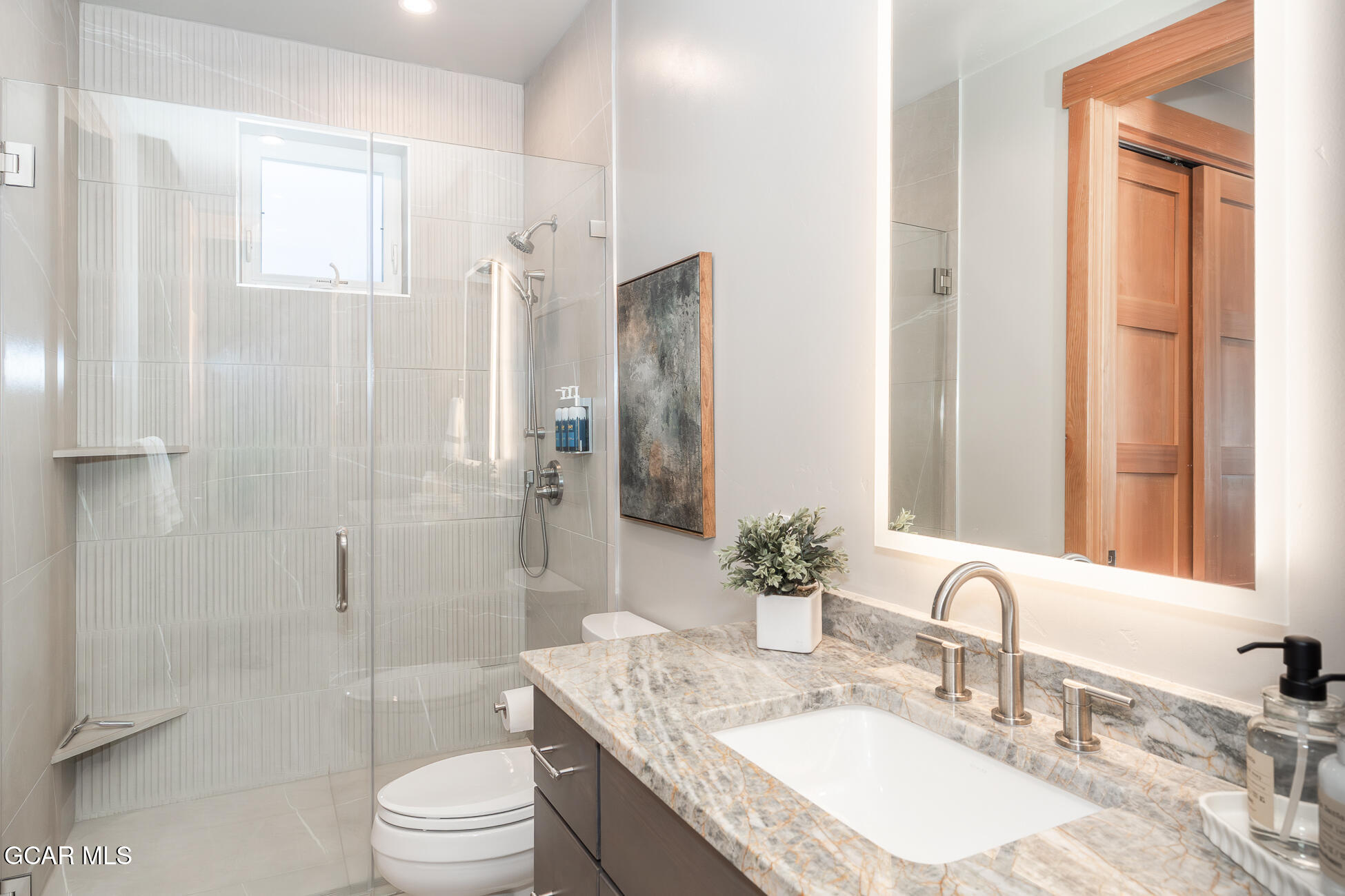 684 Vasquez Road Winter Park, CO 80482 - Photo 25 of 45 a bathroom with a granite countertop sink toilet mirror and shower