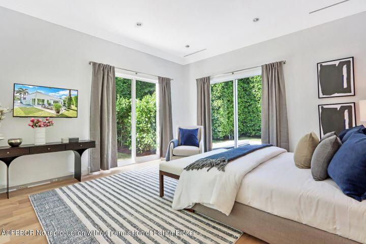 215 Indian Road Palm Beach, FL 33480 - Photo 15 of 32 a bedroom with a bed and a large window