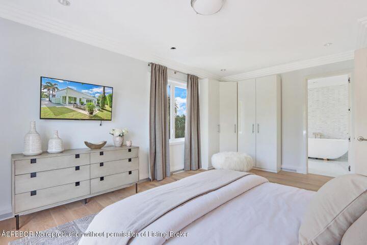 215 Indian Road Palm Beach, FL 33480 - Photo 17 of 32 a bedroom with a bed and wooden floor