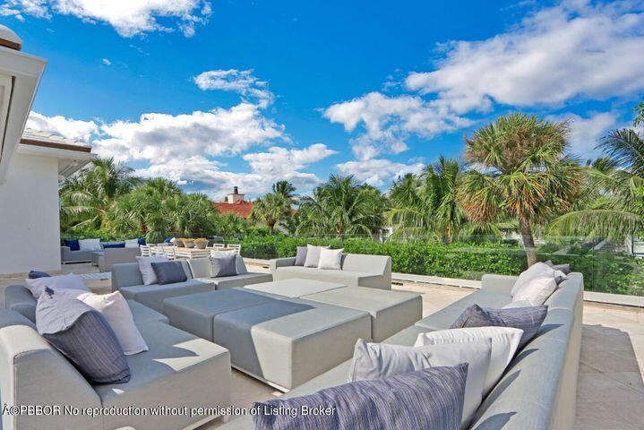 215 Indian Road Palm Beach, FL 33480 - Photo 25 of 32 a view of a patio with couches potted plants and a big yard