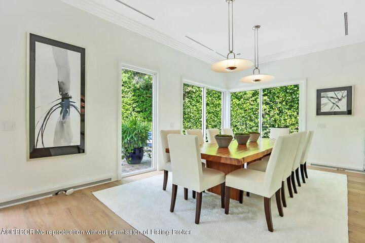 215 Indian Road Palm Beach, FL 33480 - Photo 5 of 32 a dining room with furniture a chandelier and wooden floor