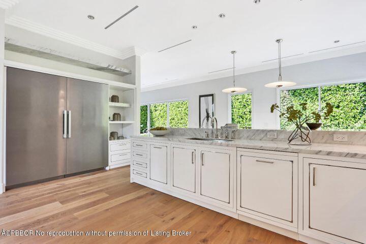 215 Indian Road Palm Beach, FL 33480 - Photo 9 of 32 a kitchen with granite countertop white cabinets and white appliances