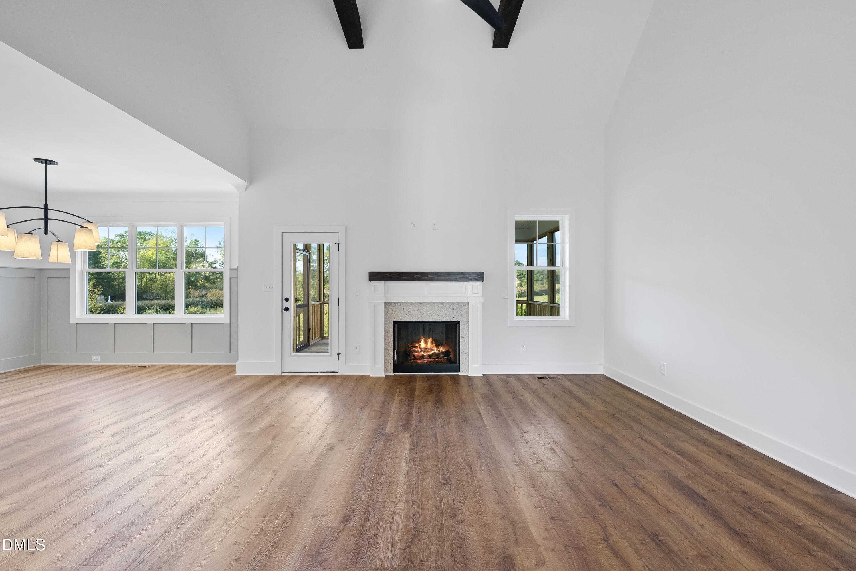 5600 River Buck Rd Spring Spring Hope, NC 27882 - Photo 30 of 31 an empty room with windows a fireplace and wooden floor