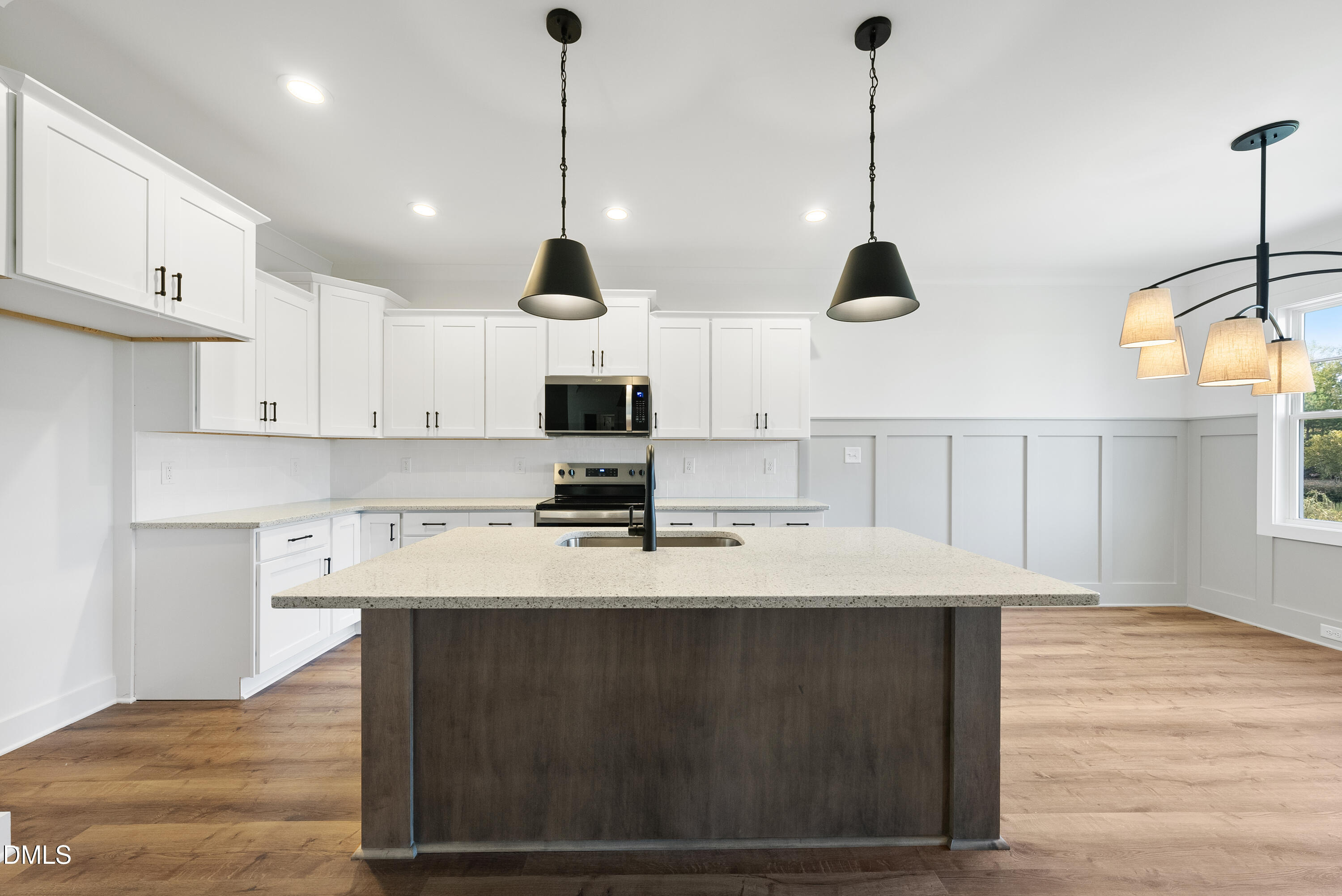 5600 River Buck Rd Spring Spring Hope, NC 27882 - Photo 8 of 31 a open kitchen with kitchen island a stove a sink a center island and wooden floor