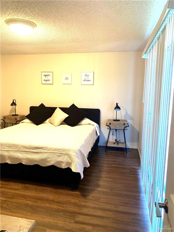 2201 South Jackson Road, Unit 35 Pharr, TX 78577 - Photo 12 of 21 a bedroom with a bed and wooden floor