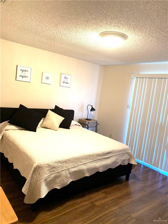 2201 South Jackson Road, Unit 35 Pharr, TX 78577 - Photo 16 of 21 a bedroom with a bed and wooden floor
