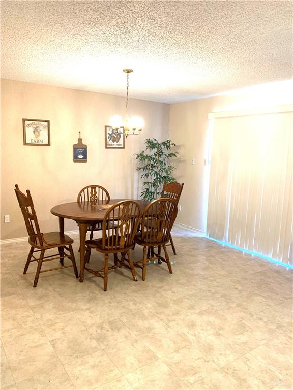 2201 South Jackson Road, Unit 35 Pharr, TX 78577 - Photo 6 of 21 a view of a dining room with furniture and wooden floor
