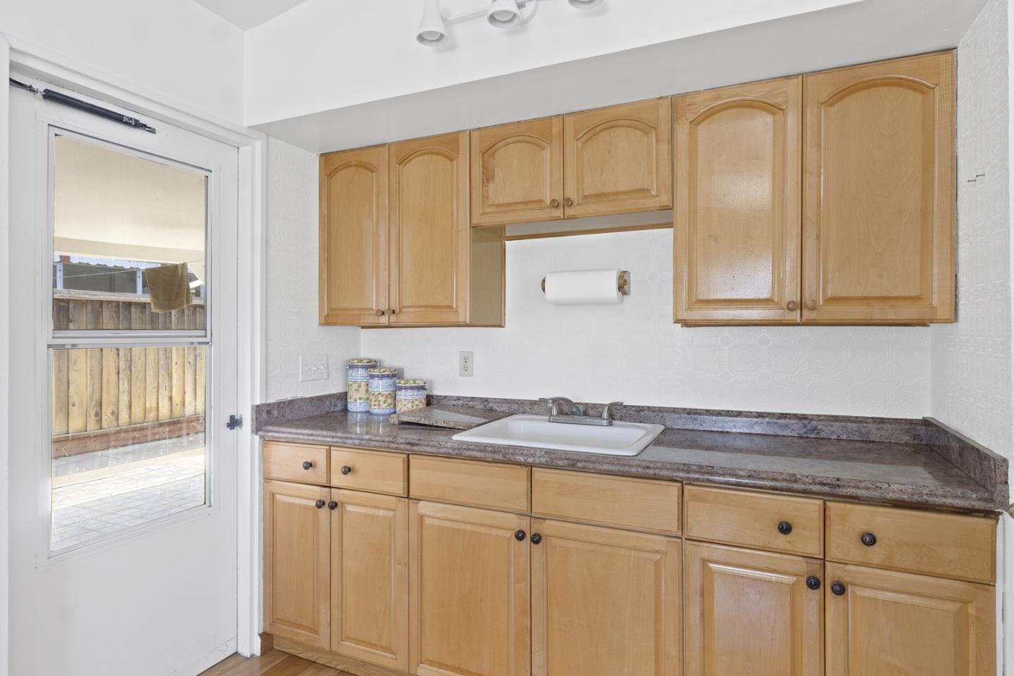 1958 Jackson Street Santa Clara, CA 95050 - Photo 11 of 22 a kitchen with stainless steel appliances granite countertop white cabinets sink and granite counter tops
