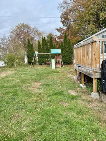 a view of a wooden deck and a yard
