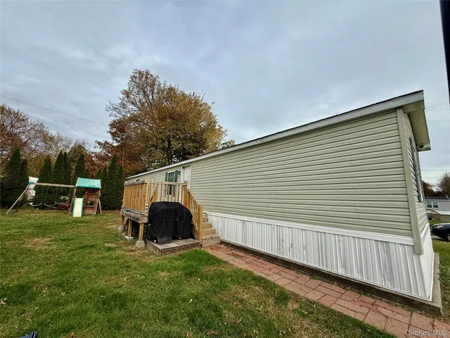a backyard of a house with table and chairs