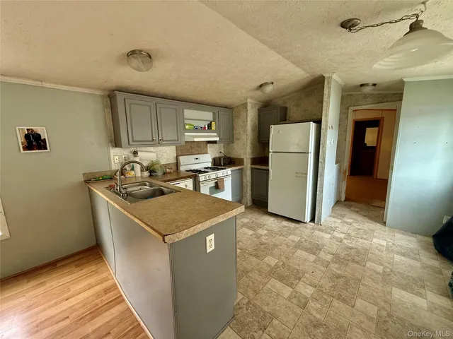 a kitchen with a stove a refrigerator and a sink