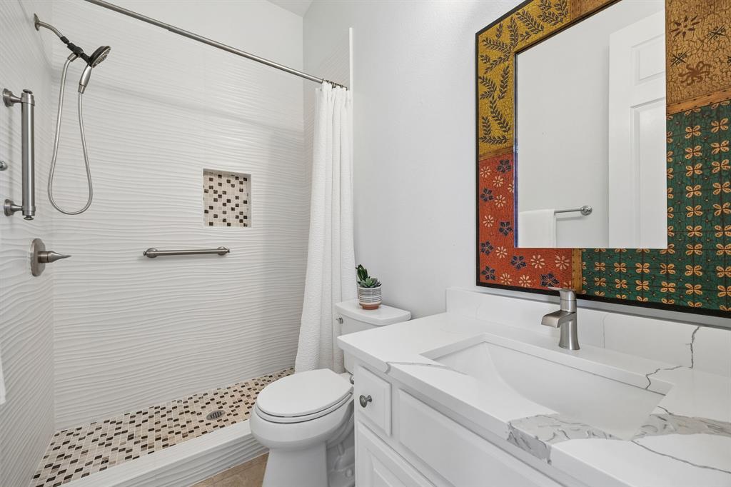 1011 Three Rivers Drive Prosper, TX 75078 - Photo 13 of 27 a bathroom with a sink a toilet and shower