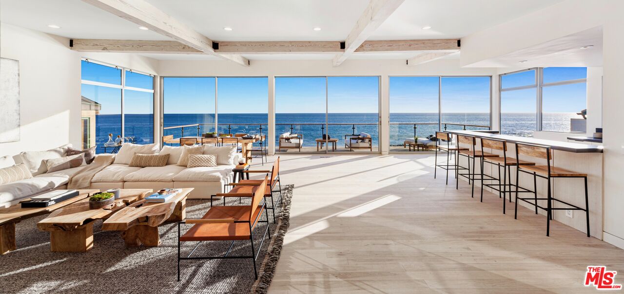 24928 Malibu Road Malibu, CA 90265 - Photo 1 of 20 a living room with lots of furniture and a view of kitchen