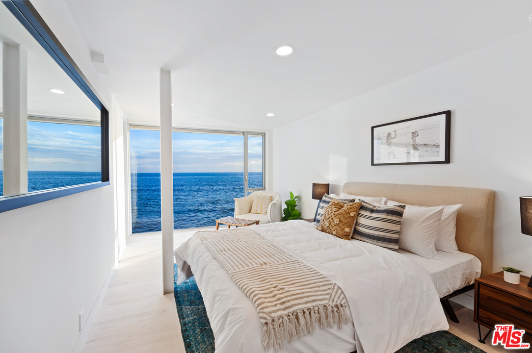 24928 Malibu Road Malibu, CA 90265 - Photo 11 of 20 a bedroom with a large bed and a painting on the wall