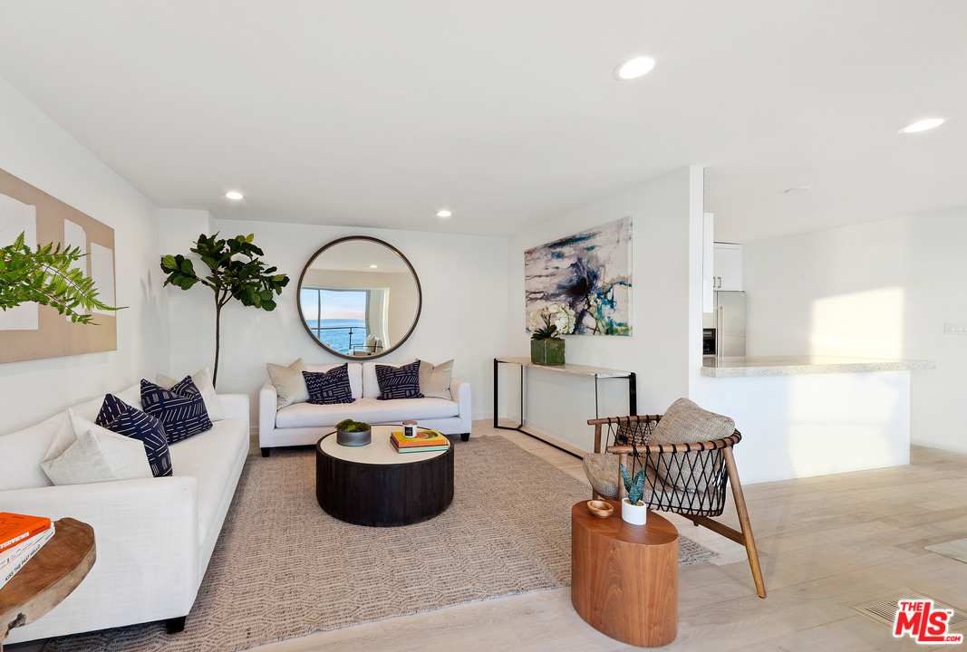 24928 Malibu Road Malibu, CA 90265 - Photo 15 of 20 a living room with furniture a potted plant and a window