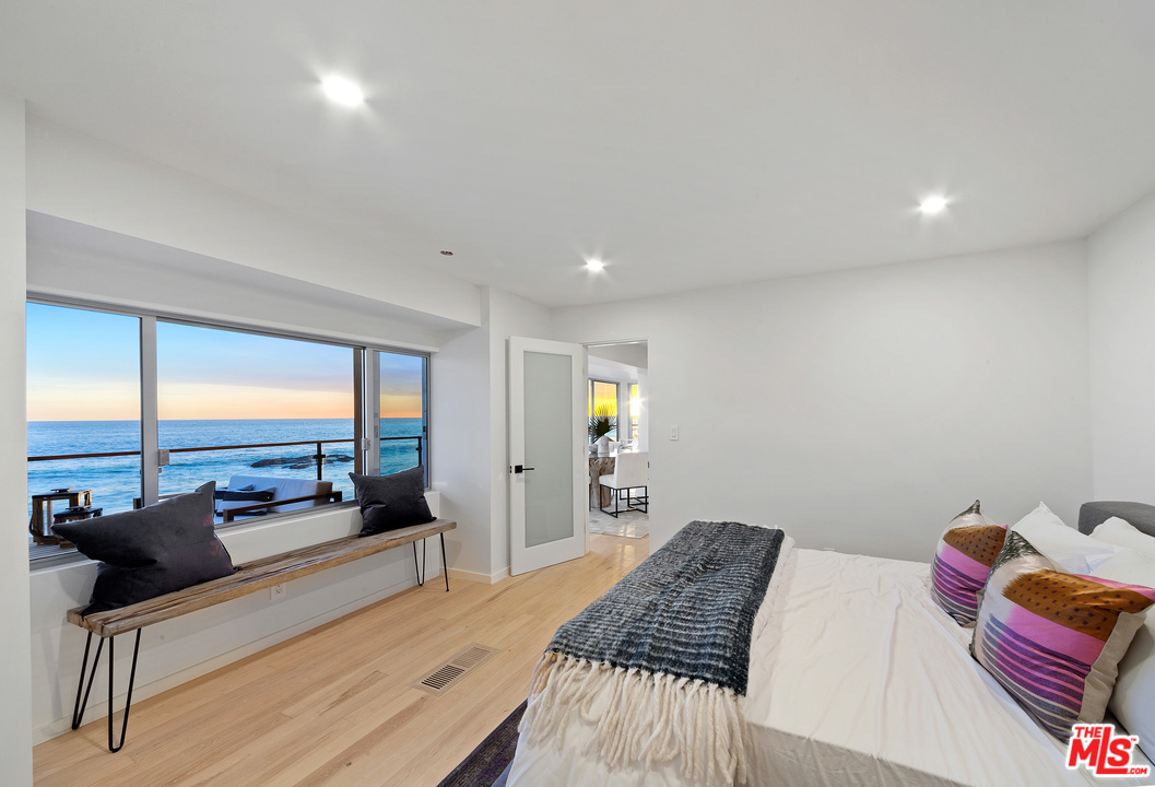 24928 Malibu Road Malibu, CA 90265 - Photo 17 of 20 a bedroom with a bed and large windows