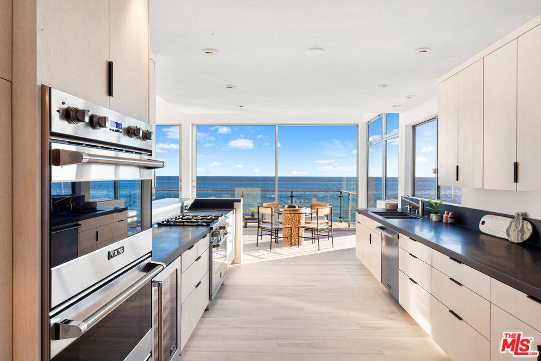 24928 Malibu Road Malibu, CA 90265 - Photo 4 of 20 a kitchen with stainless steel appliances a sink and a stove