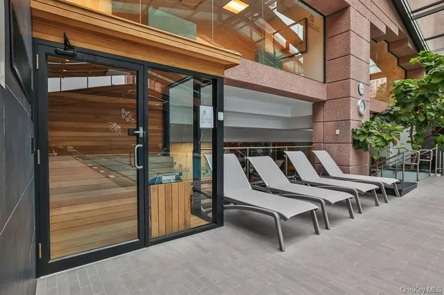 a view of a hallway with dining area and glass door