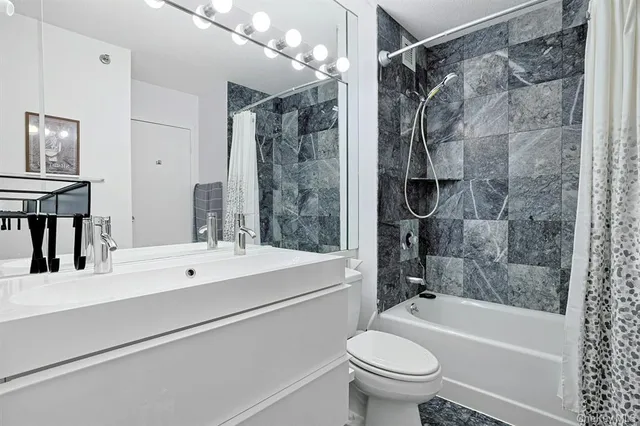 a bathroom with a sink toilet and shower