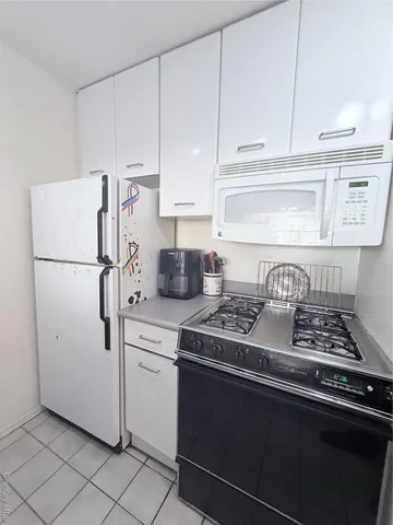 a kitchen with stainless steel appliances a refrigerator sink and cabinets