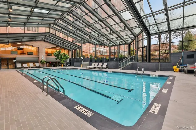 a view of a hallway with dining area and glass door