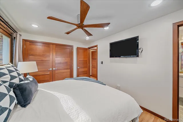 a bedroom with a bed and a flat screen tv