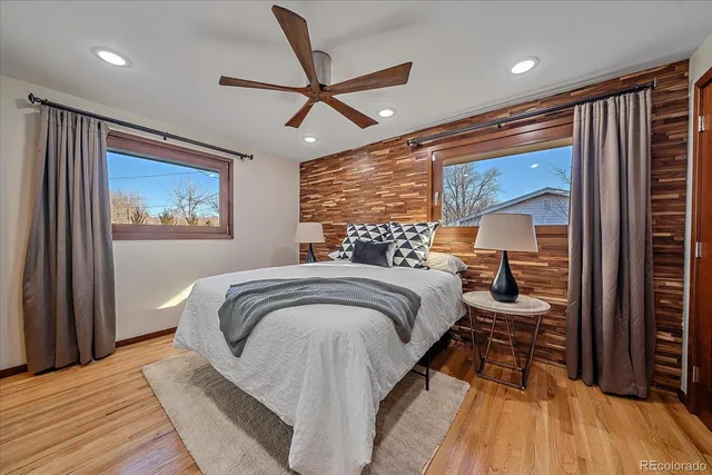 a bedroom with a large bed and a chandelier