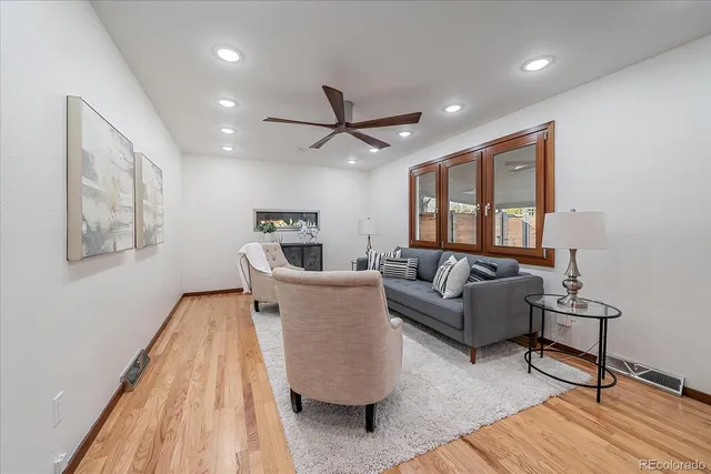 a living room with furniture and a wooden floor