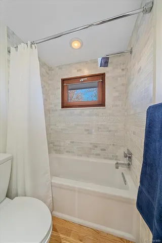 a bathroom with a toilet and a bathtub