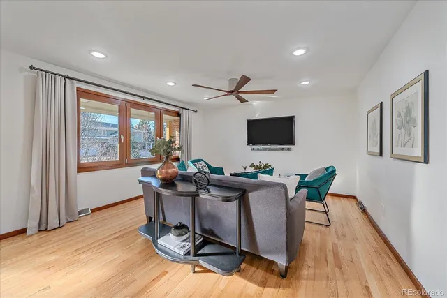 a work room with furniture and a flat screen tv